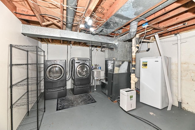 9618 W Bradley Rd, Milwaukee, WI 53224 - unfinished below grade area featuring separate washer and dryer, freestanding refrigerator, and heating unit