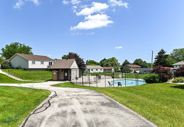 9618 W Bradley Rd, Milwaukee, WI 53224 - view of community featuring a pool, a residential view, and asphalt driveway