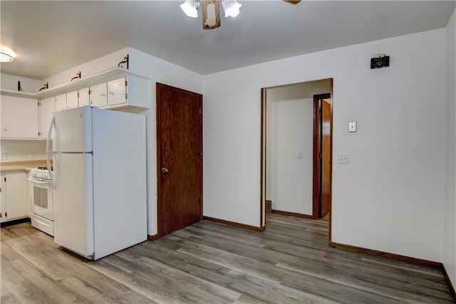3474 Delbert Rd, Eau Claire, WI 54703 - kitchen with white appliances, light wood-style flooring, light countertops, and white cabinets