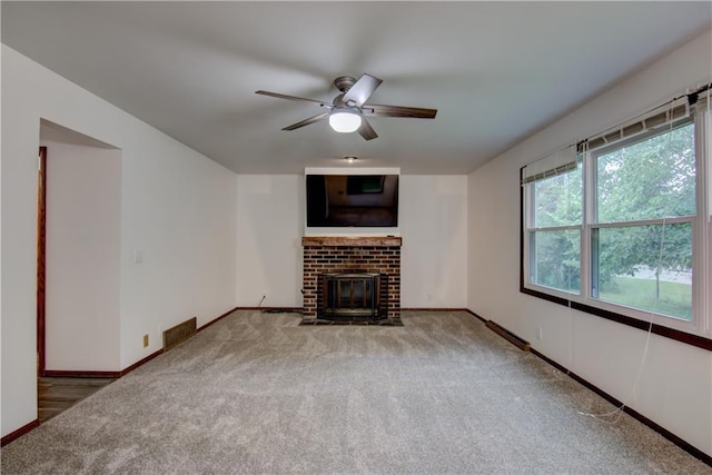 3474 Delbert Rd, Eau Claire, WI 54703 - unfurnished living room with carpet floors, ceiling fan, and a brick fireplace
