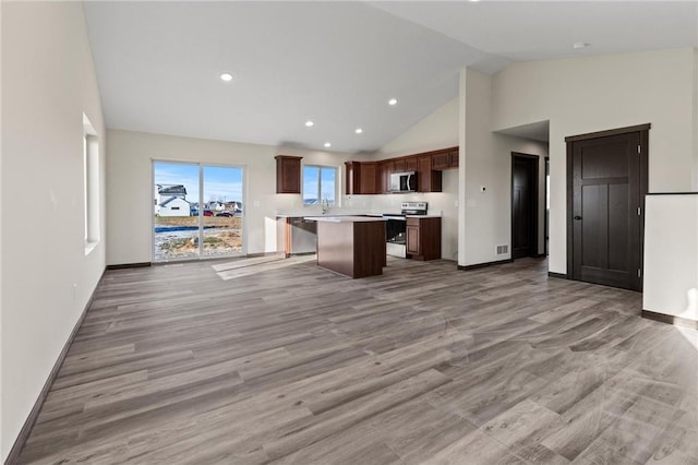 198 Pintail St, Baldwin, WI 54002 - kitchen featuring stainless steel appliances, open floor plan, high vaulted ceiling, light countertops, and a kitchen island
