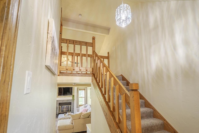 630 Brule Rd Unit 11, De Pere, WI 54115 - staircase featuring a high ceiling and a glass covered fireplace