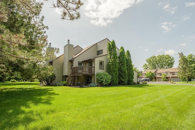 630 Brule Rd Unit 11, De Pere, WI 54115 - rear view of house with a chimney, a yard, and a deck
