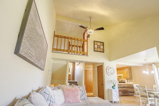630 Brule Rd Unit 11, De Pere, WI 54115 - living area with a ceiling fan, light wood-style floors, high vaulted ceiling, a chandelier, and stairway