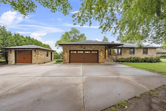 4350 S US Highway 45, Oshkosh, WI 54902 - ranch-style home featuring brick siding, concrete driveway, a front lawn, and an attached garage