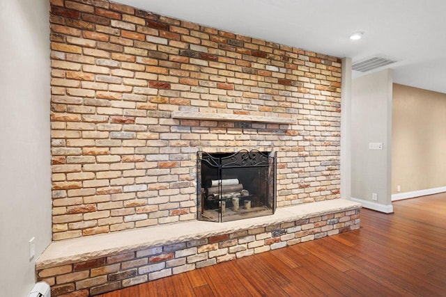 4350 S US Highway 45, Oshkosh, WI 54902 - detailed view of wood finished floors, a fireplace, and baseboard heating