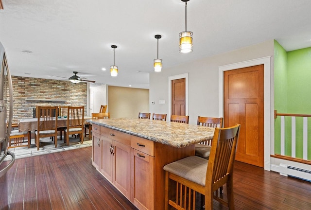 4350 S US Highway 45, Oshkosh, WI 54902 - kitchen featuring a ceiling fan, a kitchen bar, dark wood-style floors, decorative light fixtures, and brick wall
