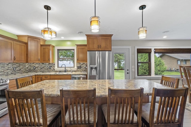 4350 S US Highway 45, Oshkosh, WI 54902 - kitchen with stainless steel appliances, tasteful backsplash, a center island, and hanging light fixtures