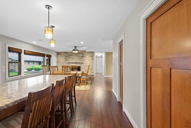 4350 S US Highway 45, Oshkosh, WI 54902 - dining space featuring ceiling fan, dark wood-style floors, a fireplace, and recessed lighting