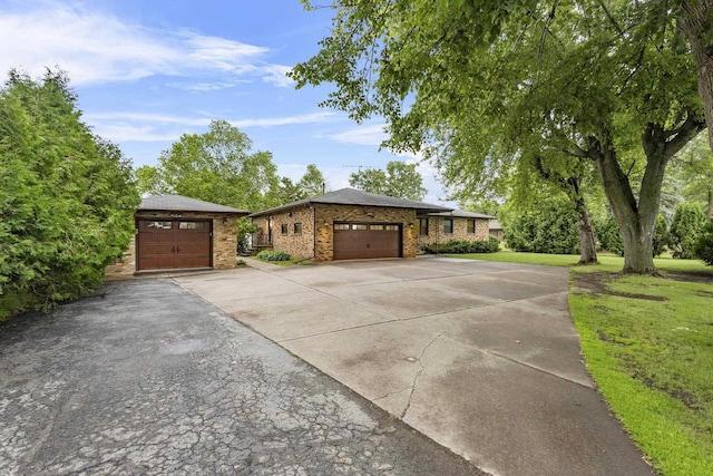 4350 S US Highway 45, Oshkosh, WI 54902 - view of front of home with concrete driveway, a front yard, an attached garage, and brick siding