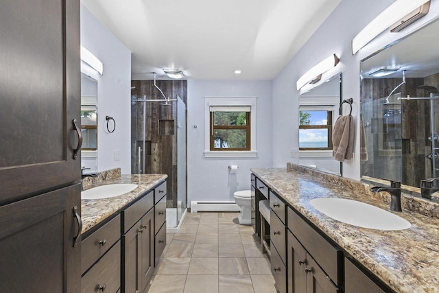 4350 S US Highway 45, Oshkosh, WI 54902 - full bathroom with baseboard heating, a stall shower, two vanities, marble finish flooring, and recessed lighting