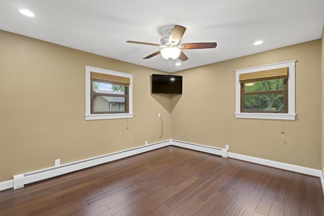 4350 S US Highway 45, Oshkosh, WI 54902 - unfurnished room featuring healthy amount of natural light, a ceiling fan, dark wood-style floors, a baseboard heating unit, and recessed lighting