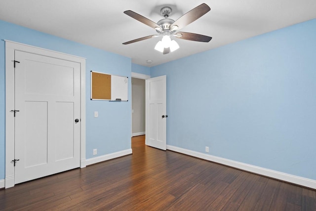 4350 S US Highway 45, Oshkosh, WI 54902 - unfurnished bedroom featuring dark wood-style flooring and a ceiling fan