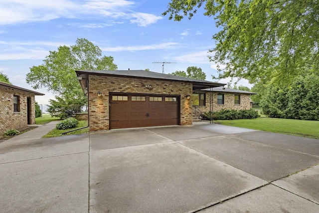4350 S US Highway 45, Oshkosh, WI 54902 - view of front of property with driveway, brick siding, a front lawn, and an attached garage