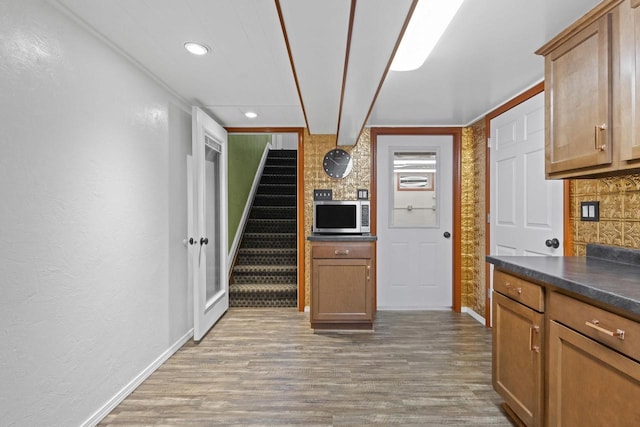4350 S US Highway 45, Oshkosh, WI 54902 - kitchen featuring stainless steel microwave, wood finished floors, dark countertops, recessed lighting, and tasteful backsplash