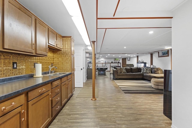 4350 S US Highway 45, Oshkosh, WI 54902 - kitchen featuring decorative backsplash, dark countertops, light wood finished floors, recessed lighting, and open floor plan