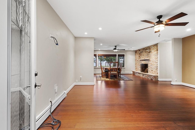 4350 S US Highway 45, Oshkosh, WI 54902 - living area with ceiling fan, a baseboard radiator, wood finished floors, a fireplace, and recessed lighting