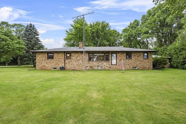 4350 S US Highway 45, Oshkosh, WI 54902 - rear view of house with a chimney, a lawn, and brick siding