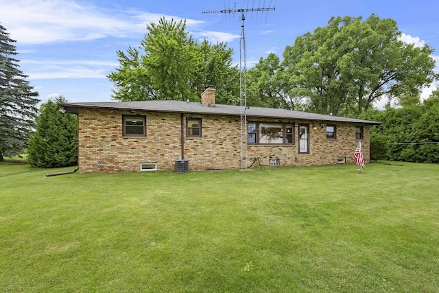 4350 S US Highway 45, Oshkosh, WI 54902 - rear view of property featuring brick siding, a chimney, and a lawn