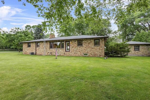 4350 S US Highway 45, Oshkosh, WI 54902 - view of front facade with a chimney, a front yard, and brick siding
