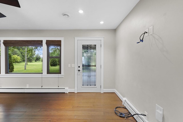 4350 S US Highway 45, Oshkosh, WI 54902 - foyer entrance featuring healthy amount of natural light, a baseboard radiator, wood-type flooring, and recessed lighting