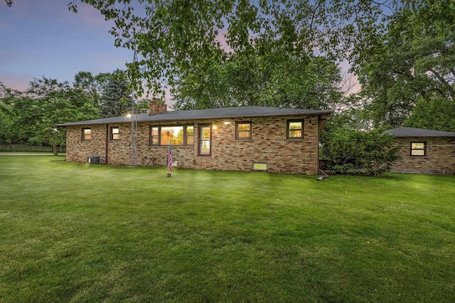 4350 S US Highway 45, Oshkosh, WI 54902 - view of front of home with a chimney, a lawn, and brick siding