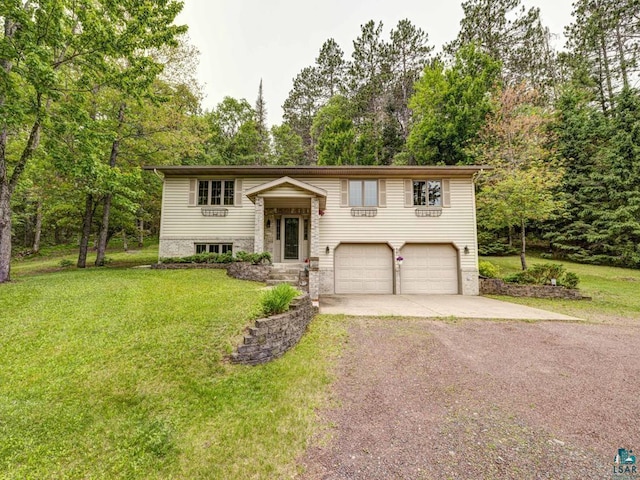 10811 S Patterson Rd, Solon Springs, WI 54873 - raised ranch with driveway, a garage, a front yard, and view of scattered trees