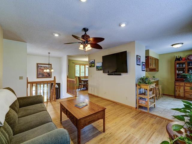 10811 S Patterson Rd, Solon Springs, WI 54873 - living room with a textured ceiling, light wood-style flooring, ceiling fan, a chandelier, and recessed lighting