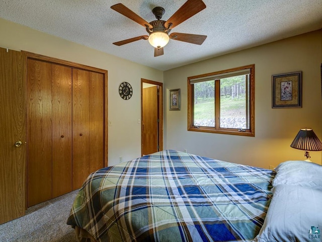 10811 S Patterson Rd, Solon Springs, WI 54873 - bedroom featuring carpet flooring, a closet, a textured ceiling, and ceiling fan