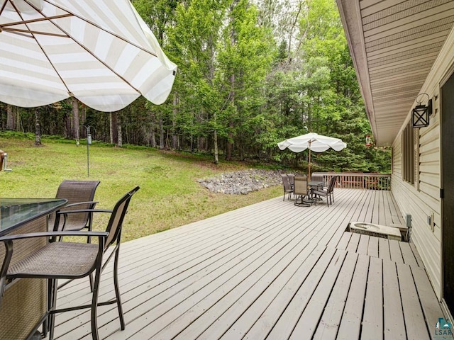 10811 S Patterson Rd, Solon Springs, WI 54873 - wooden deck with outdoor dining space and a lawn