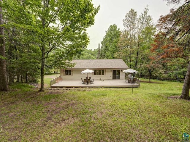 10811 S Patterson Rd, Solon Springs, WI 54873 - rear view of property featuring a deck, a yard, a wooded view, and outdoor dining area