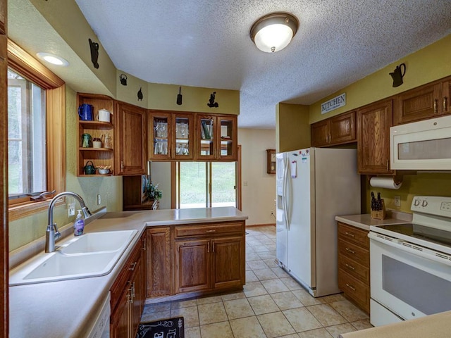 10811 S Patterson Rd, Solon Springs, WI 54873 - kitchen featuring white appliances, a peninsula, a textured ceiling, light countertops, and brown cabinets