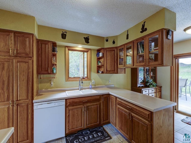 10811 S Patterson Rd, Solon Springs, WI 54873 - kitchen featuring white dishwasher, open shelves, brown cabinetry, a textured ceiling, and a peninsula