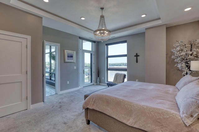 215 E Pleasant St Unit 304, Oconomowoc, WI 53066 - carpeted bedroom with access to exterior, a chandelier, multiple windows, recessed lighting, and a raised ceiling