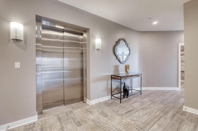 215 E Pleasant St Unit 304, Oconomowoc, WI 53066 - hall with elevator, wood finished floors, and recessed lighting