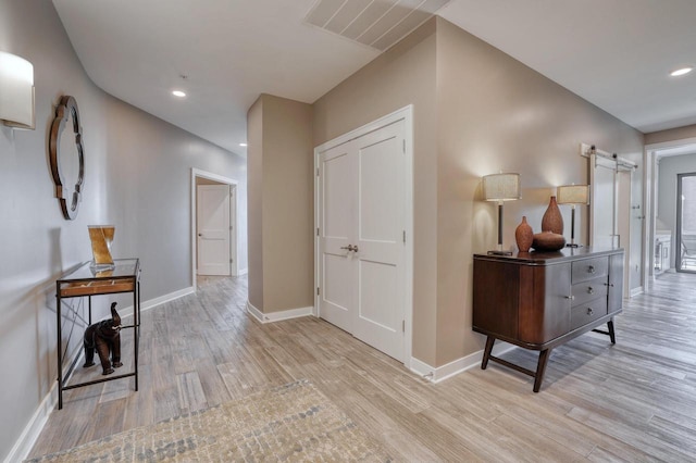215 E Pleasant St Unit 304, Oconomowoc, WI 53066 - hall featuring light wood-style flooring, a barn door, and recessed lighting