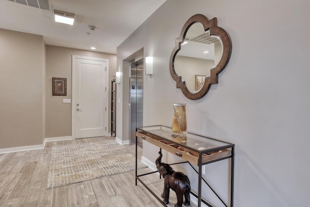 215 E Pleasant St Unit 304, Oconomowoc, WI 53066 - entryway with light wood finished floors, elevator, and recessed lighting