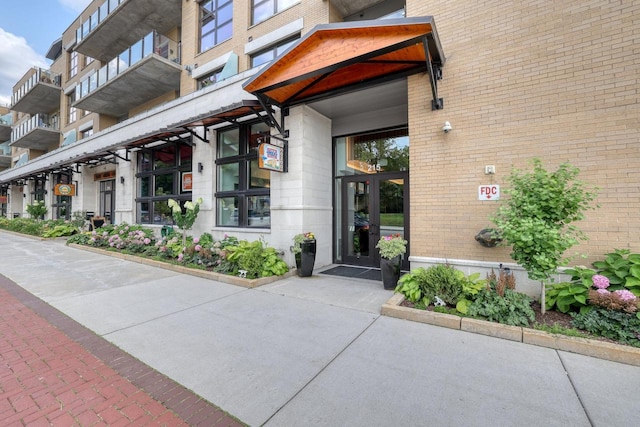 215 E Pleasant St Unit 304, Oconomowoc, WI 53066 - property entrance featuring brick siding