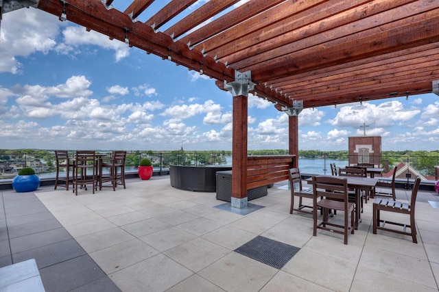 215 E Pleasant St Unit 304, Oconomowoc, WI 53066 - view of patio with a pergola, outdoor dining space, and a water view