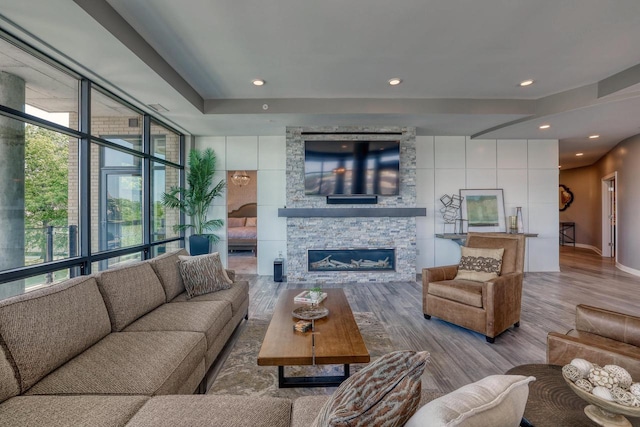 215 E Pleasant St Unit 304, Oconomowoc, WI 53066 - living room featuring wood finished floors, a fireplace, and recessed lighting