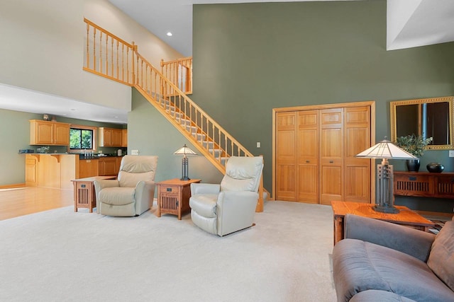 5330 Deer Trail Ln, Sheboygan, WI 53083 - living room featuring a towering ceiling, stairway, light carpet, and recessed lighting