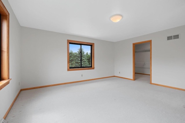 5330 Deer Trail Ln, Sheboygan, WI 53083 - unfurnished bedroom featuring light carpet, a spacious closet, and a closet