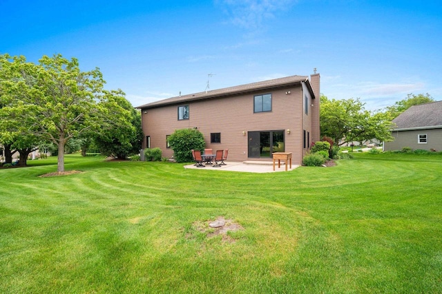 5330 Deer Trail Ln, Sheboygan, WI 53083 - rear view of house featuring a chimney, a patio, and a yard