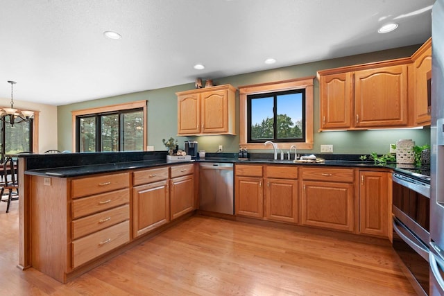 5330 Deer Trail Ln, Sheboygan, WI 53083 - kitchen featuring stainless steel appliances, a peninsula, light wood-style floors, recessed lighting, and pendant lighting