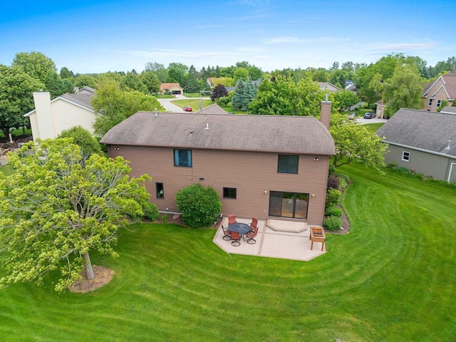 5330 Deer Trail Ln, Sheboygan, WI 53083 - rear view of property with a patio, a yard, a residential view, a chimney, and view of wooded area