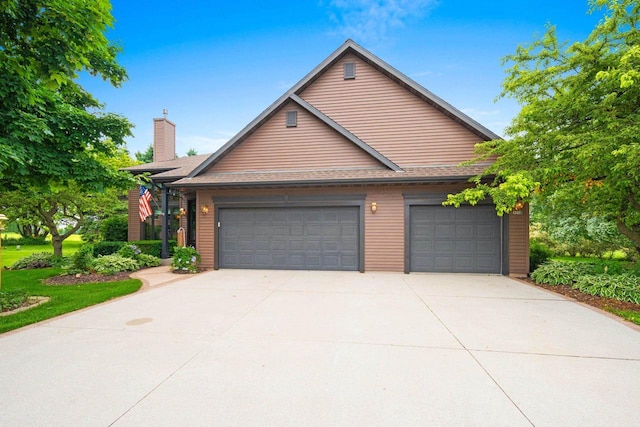 5330 Deer Trail Ln, Sheboygan, WI 53083 - view of front of home with a chimney, driveway, and a garage