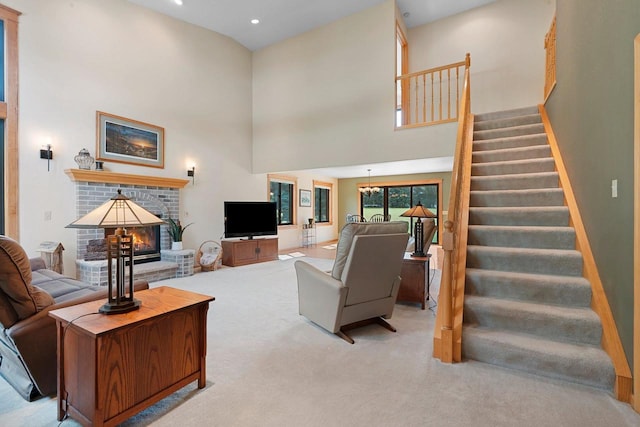 5330 Deer Trail Ln, Sheboygan, WI 53083 - carpeted living room featuring stairway, a towering ceiling, a fireplace, and recessed lighting
