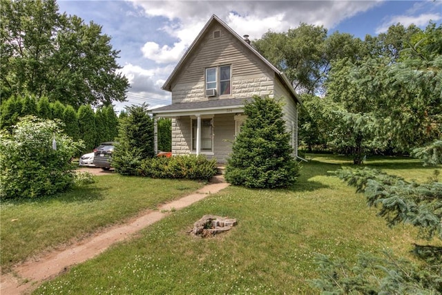 324 Mead St, Eau Claire, WI 54703 - view of property exterior featuring covered porch, a lawn, stone siding, and cooling unit