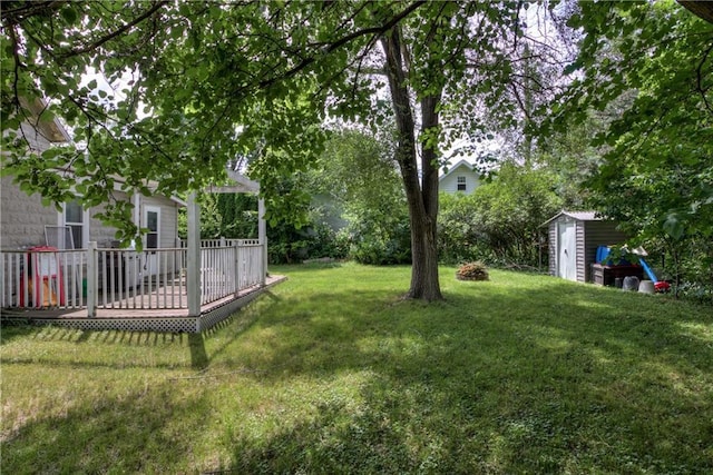 324 Mead St, Eau Claire, WI 54703 - view of grassy yard with a storage shed and a wooden deck