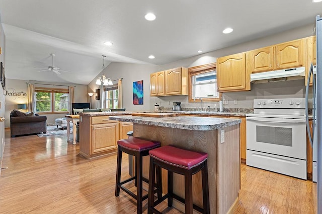 1630 Central St, Oshkosh, WI 54901 - kitchen with white range with electric cooktop, under cabinet range hood, light brown cabinets, a center island, and light wood-style floors